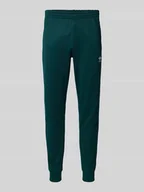 Spodnie sportowe męskie - Spodnie dresowe o kroju slim fit z wyhaftowanym logo - miniaturka - grafika 1