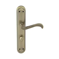 Klamki - Domino Klamka do drzwi wewnętrznych z długim szyldem do wc Casablanka 72 mm Prawa mosiądz/patyna - miniaturka - grafika 1