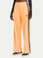 Spodnie sportowe damskie - adidas Spodnie dresowe adicolor Classic Firebird JY2694 Żółty Loose Fit - miniaturka - grafika 1