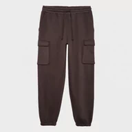 Spodnie sportowe męskie - Męskie spodnie dresowe Outhorn OTHAW23TTROM513 - brązowe - miniaturka - grafika 1