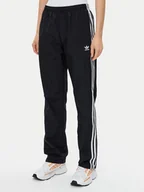 Spodnie sportowe damskie - adidas Spodnie dresowe Woven JD5335 Czarny Loose Fit - miniaturka - grafika 1