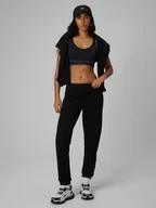 Spodnie sportowe damskie - 4F Spodnie dresowe joggery damskie - czarne XXL - miniaturka - grafika 1