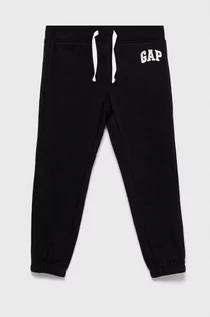 Spodnie i spodenki dla dziewczynek - GAP spodnie dresowe dziecięce kolor czarny z nadrukiem - Gap - grafika 1