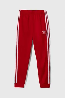 Spodnie i spodenki dla dziewczynek - adidas Originals spodnie dresowe dziecięce kolor czerwony wzorzyste - grafika 1