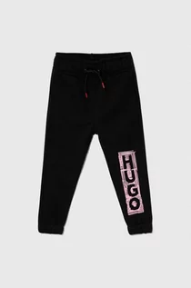 Spodnie i spodenki dla dziewczynek - HUGO spodnie dresowe bawełniane dziecięce kolor czarny z nadrukiem - Hugo - grafika 1