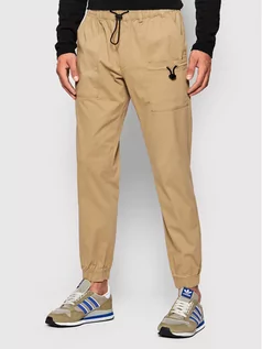 Spodnie męskie - Outhorn Spodnie materiałowe SPMC601 Beżowy Regular Fit - grafika 1
