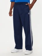 Spodnie sportowe męskie - adidas Spodnie dresowe adicolor Firebird IZ2466 Granatowy Baggy Fit - miniaturka - grafika 1