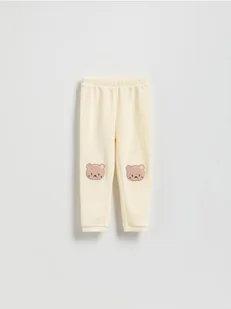 Reserved - Prążkowane legginsy z naszywką - złamana biel - Spodnie i spodenki dla dziewczynek - miniaturka - grafika 1