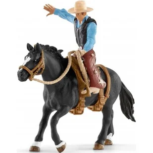 Schleich 41416 KOWBOJ SIODŁAJĄCY DZIKIEGO KONIA SCH41416 - Figurki dla dzieci - miniaturka - grafika 1