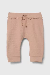 Spodnie i spodenki dla dziewczynek - United Colors of Benetton spodnie dresowe niemowlęce kolor różowy gładkie - grafika 1