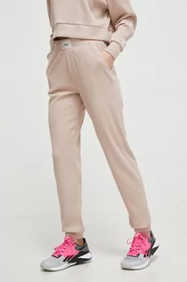 Spodnie damskie - Guess spodnie dresowe kolor beżowy gładkie - grafika 1