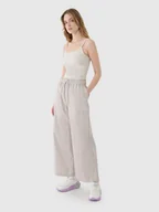 Spodnie sportowe damskie - 4F Spodnie casual z szerokimi nogawkami damskie - beżowe L - miniaturka - grafika 1