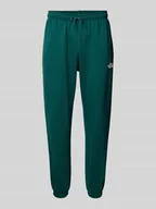 Spodnie sportowe męskie - Spodnie dresowe o kroju regular tapered fit z nadrukiem z logo - miniaturka - grafika 1