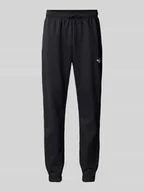 Spodnie sportowe męskie - Spodnie dresowe o kroju regular tapered fit z nadrukiem z logo - miniaturka - grafika 1