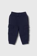 Spodnie i spodenki dla chłopców - United Colors of Benetton spodnie dresowe bawełniane dziecięce kolor granatowy gładkie - miniaturka - grafika 1