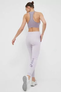 Spodnie damskie - Asics spodnie dresowe kolor fioletowy z nadrukiem - grafika 1