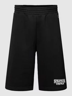 Spodnie sportowe męskie - Spodnie dresowe z wyhaftowanym logo — Champion x Stranger Things - grafika 1