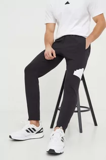 Spodnie męskie - adidas spodnie dresowe kolor czarny z nadrukiem - grafika 1