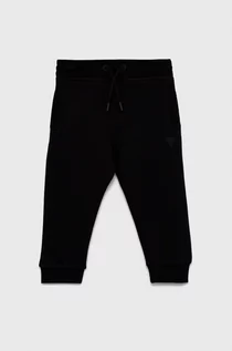 Spodnie damskie - Guess Spodnie dziecięce kolor czarny melanżowe - grafika 1