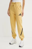 Spodnie damskie - adidas spodnie dresowe ZNE kolor żółty z nadrukiem JE7847 - miniaturka - grafika 1