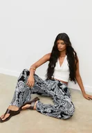 Spodnie damskie - Stradivarius Luźne wzorzyste spodnie palazzo Czarny XL - miniaturka - grafika 1