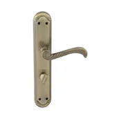 Klamki - Domino Klamka do drzwi wewnętrznych z długim szyldem do wc Casablanka 72 mm Prawa mosiądz/patyna - miniaturka - grafika 1