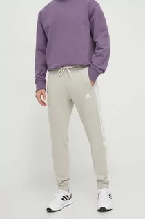 Spodnie męskie - adidas spodnie dresowe kolor szary z aplikacją - grafika 1