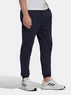 Spodnie sportowe męskie - Adidas Spodnie dresowe "Feelcozy" w kolorze granatowym - miniaturka - grafika 1