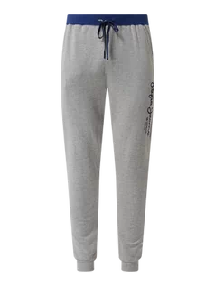 Spodnie sportowe męskie - Spodnie dresowe z nadrukiem z logo model ‘Minep’ - grafika 1