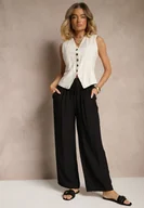 Spodnie damskie - Czarne Spodnie Typu Palazzo o Szerokim Kroju High Waist Ozdobione Wiązaniem Yaslevia - miniaturka - grafika 1