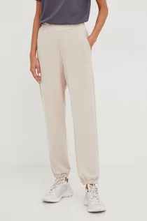 Spodnie damskie - 4F spodnie dresowe damskie kolor beżowy gładkie - grafika 1