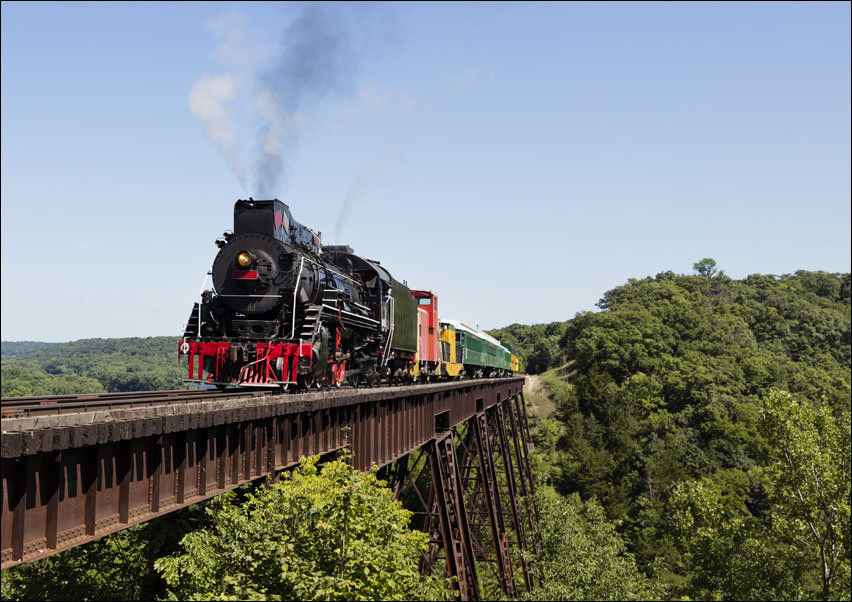 A steam train on a heritage railroad that operates excursions in Boone County, Iowa, crosses the 156-foot-tall Bass Point Creek Bridge., Carol Highsmi