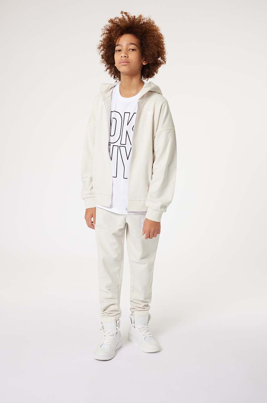 Dkny spodnie dresowe bawełniane dziecięce kolor biały z nadrukiem - DKNY