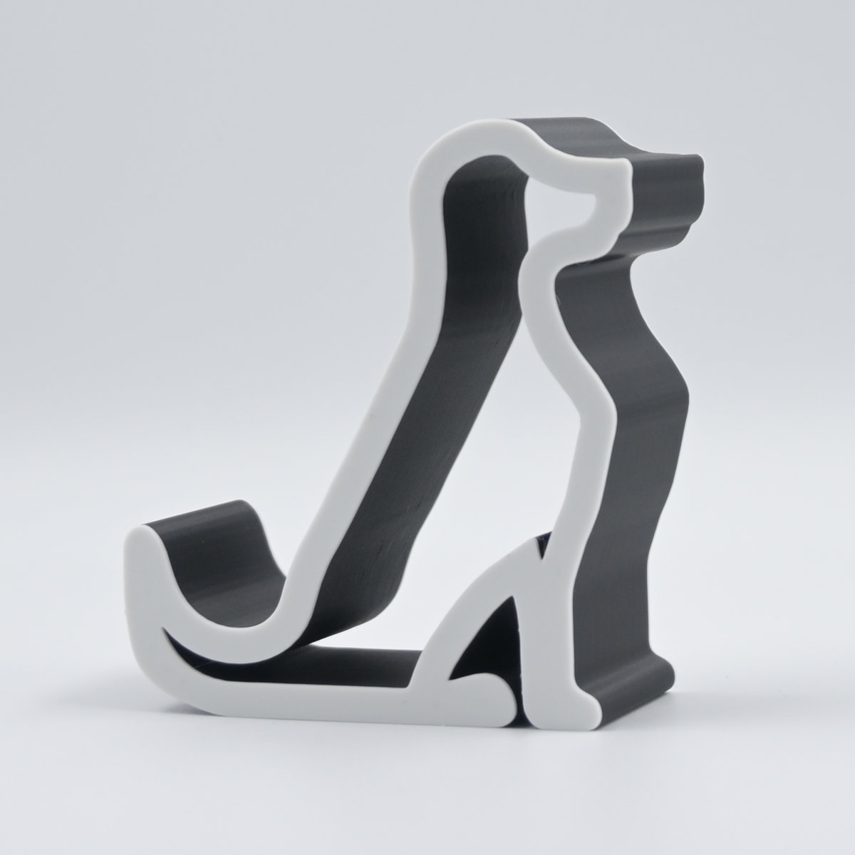 Stojak na telefon lub ozdoba na półkę w kształcie psa czarno-biały