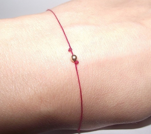 Złota 585 kuleczka na czerwonej nitce
