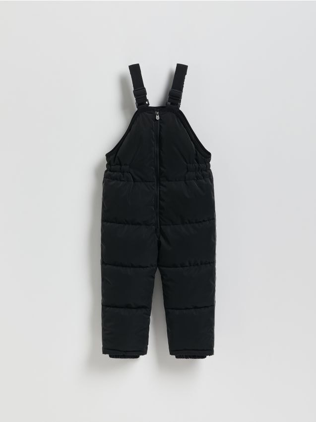 Reserved - Gumowane spodnie na szelkach - czarny