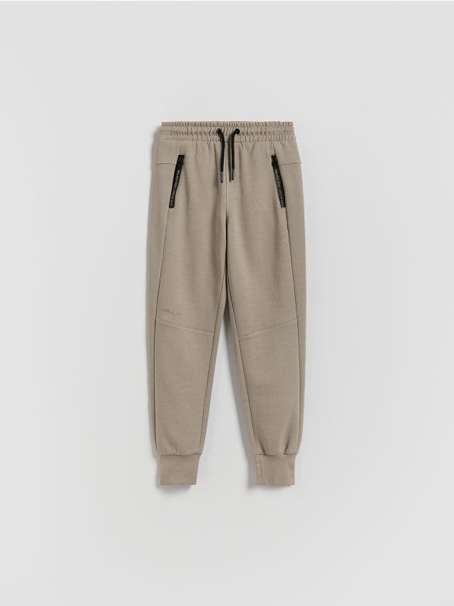Reserved - Bawełniane spodnie jogger - beżowy