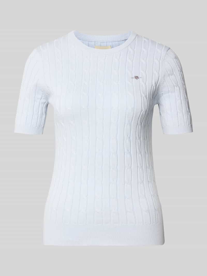 Bluzka z dzianiny ze ściegiem warkoczowym i wyhaftowanym logo