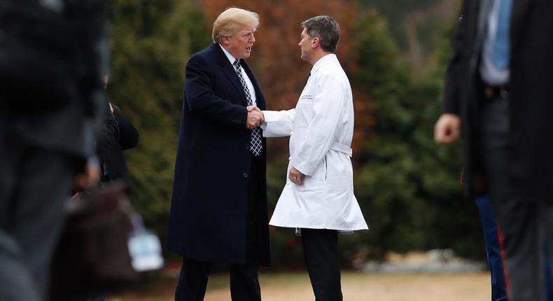 Donald Trump shakes hands with Ronny Jackson, the White House physician for part of his presidency.Carolyn Caster/AP