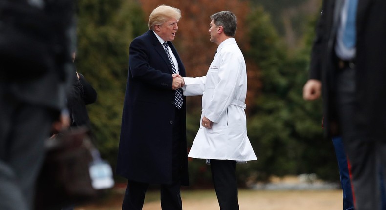 Donald Trump shakes hands with Ronny Jackson, the White House physician for part of his presidency.Carolyn Caster/AP