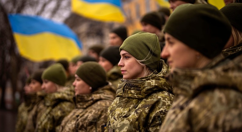 Ukrainian Army soldiers pose for a photo as they gather to celebrate a Day of Unity in Odessa, Ukraine, Wednesday, Feb. 16, 2022.