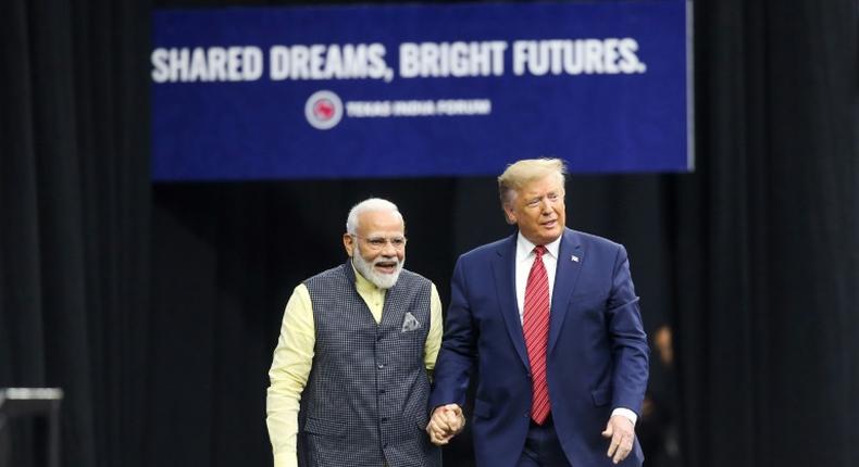 Indian Prime Minister Narendra Modi and US President Donald Trump hold hands at the event in Houston billed as the largest gathering by a foreign leader other than the pope in the United States