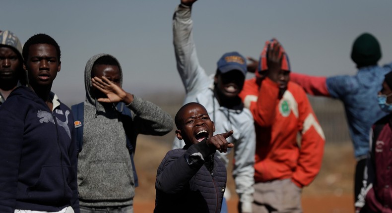 A group of men shout as they try to enter a shopping mall in Vosloorus, east of Johannesburg, South Africa on July 14.
