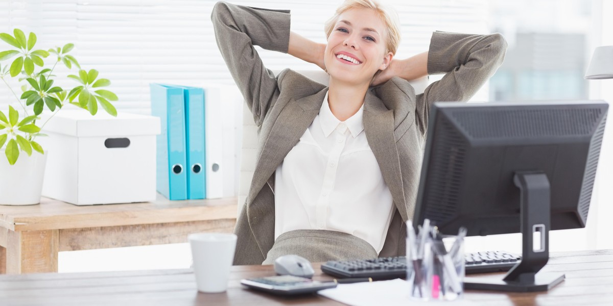 Smiling businesswoman looking at camera in her office