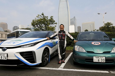 Toyota Motor Corp President Toyoda poses with the company's hydrogen fuel cell vehicle (FCV) sedan c