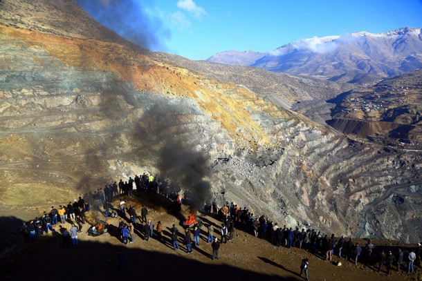 Relatives and friends watch a rescue operation for miners who were trapped at a copper mine after it