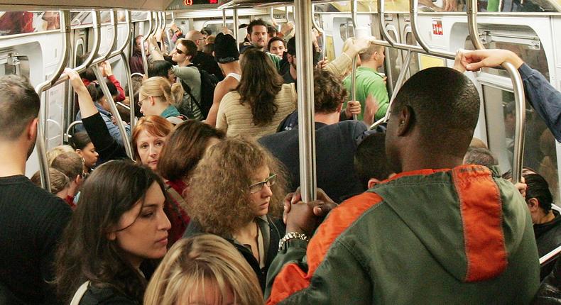 A group of subway riders packed into a crowded subway car, much like how the stocks on this list are crowded with active managers.