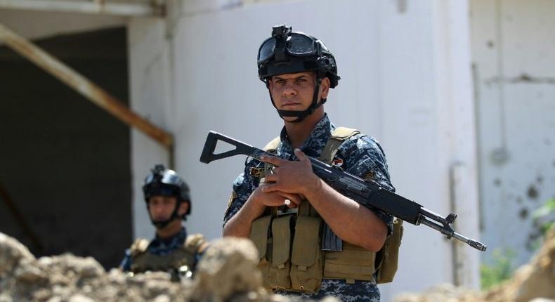 Iraqi security personnel hold a position on the front line in Mosul's Old City on May 3, 2017