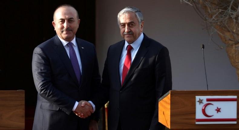 Turkish Cypriot leader Mustafa Akinci (right) holds a press conference with Turkish Foreign Minister Mevlut Cavusoglu after a meeting in the self-proclaimed Turkish Republic of Northern Cyprus (TRNC) on February 21, 2017