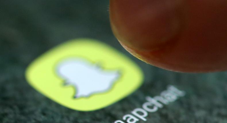 FILE PHOTO: The Snapchat app logo is seen on a smartphone in this picture illustration taken September 15, 2017. REUTERS/Dado Ruvic/Illustration